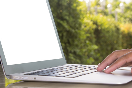 Laptop on stone table with garden backgroundの写真素材