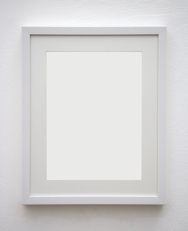 Blank photo frame at the wallの写真素材