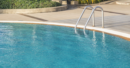 Grab bars ladder in blue swimming poolの写真素材
