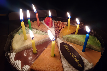 Cake with candles and happy birthday chocolate label の写真素材