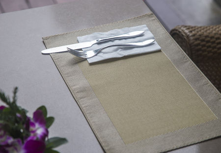 Fork and knife with napkin on table for breakfastの写真素材