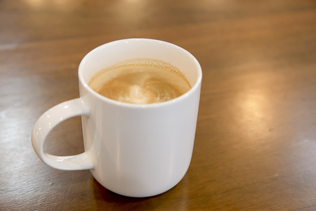 Cup of coffee on wooden table backgroundの写真素材