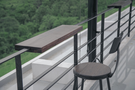 Fence with a wooden tray and chair