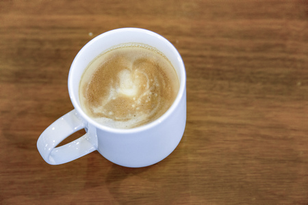 Cup of coffee on wooden table backgroundの写真素材