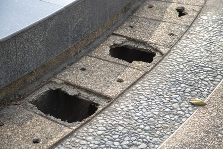 Cover pipe for drainage broken on sidewalkの写真素材