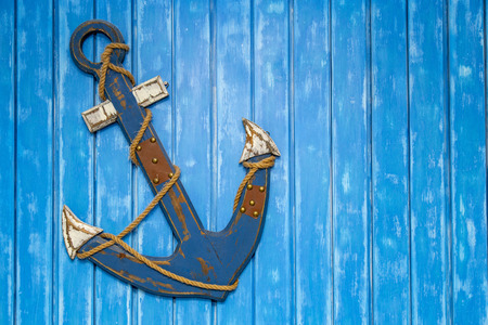 Anchor decoration on wooden plank wall background