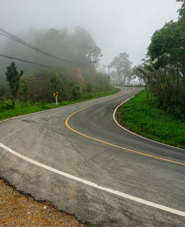Asphalt road with curve on the mountainの写真素材