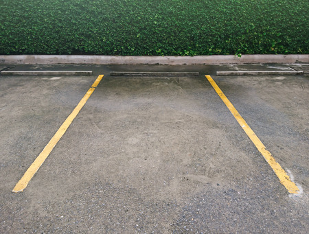 Empty parking with yellow marking line on floorの写真素材