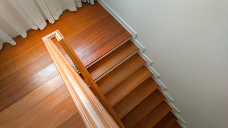 Interior with wooden staircase and white wallの写真素材