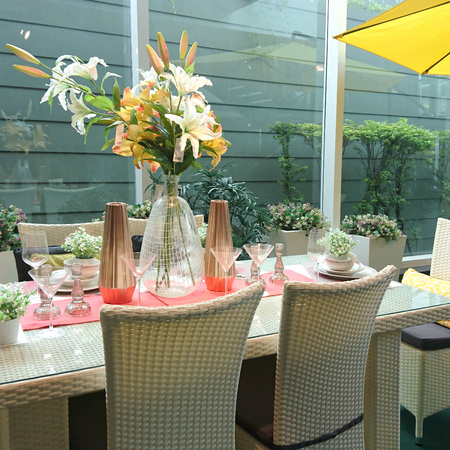 Dinner table setting decorated with flowersの写真素材