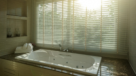 Bathtub interior of modern bathroom with sunlightの写真素材