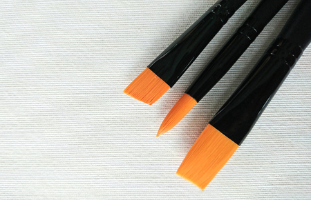 New paint brushes on canvas white backgroundの写真素材