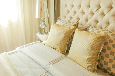 Pillows on bed and lamp in bedroom