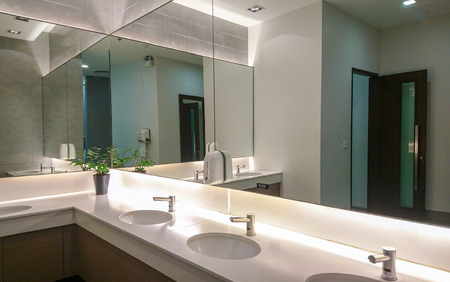 Faucets with washbasin and big mirror in public restroomのeditorial素材