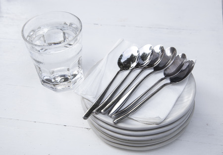 Dessert plate and spoon on wooden tableの写真素材