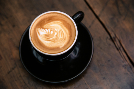 Cup of coffee on wooden table backgroundの写真素材