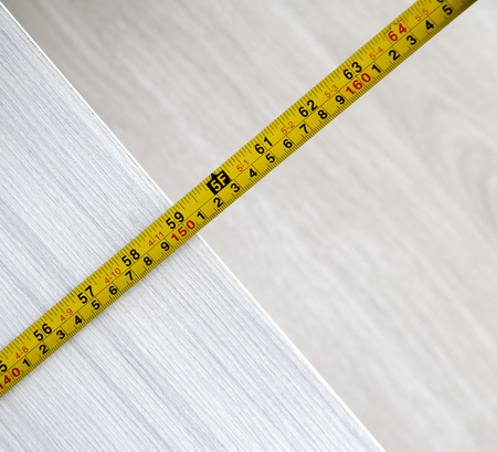 View of tape measure on wooden background