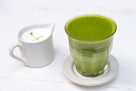 Green tea matcha latte with steam milk on the tableの写真素材