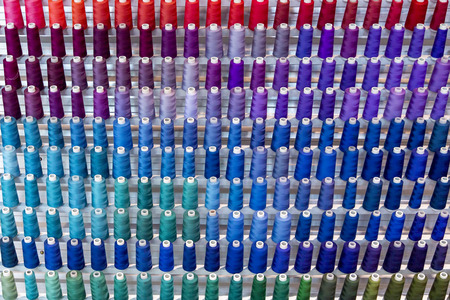 Colorful thread spool decoration of wall backgroundの写真素材