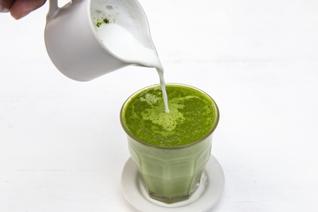 Green tea matcha latte with steam milk on the tableの写真素材