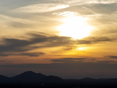 Sunset in cloud with small town and mountainの写真素材