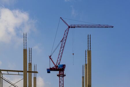 Construction of building with tower cranes against skyの写真素材