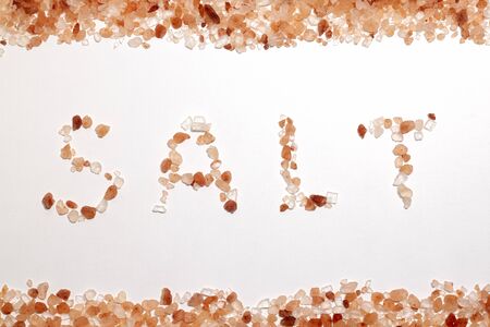 Himalayan pink salt on white table backgroundの写真素材