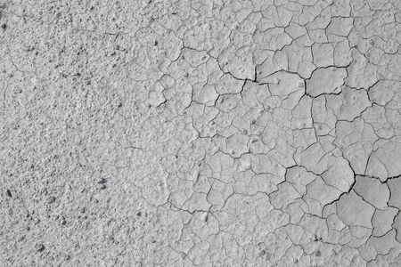 Dried cracked clay texture and gravel stonesの写真素材