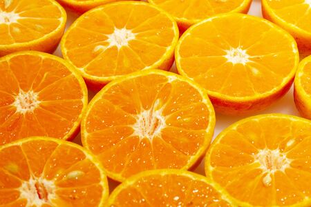 Fresh oranges cut in half before squeezing to juiceの写真素材