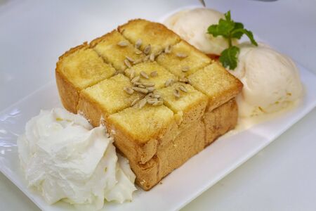 Honey toast with vanilla ice cream and whipped creamの写真素材