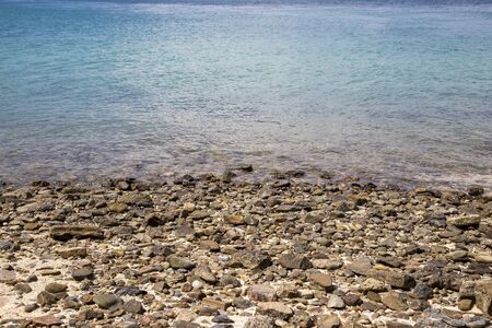 Stones pebble at the coast with seaの写真素材