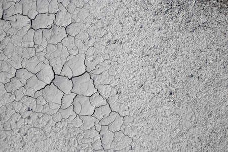 Dried cracked clay texture and gravel stonesの写真素材