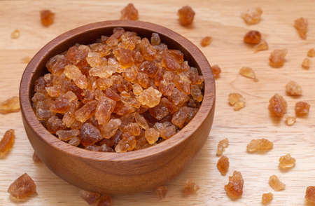 Brown rock sugar in the wooden bowlの写真素材