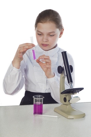 girl with a microscope and tubes conducts laboratory study の写真素材