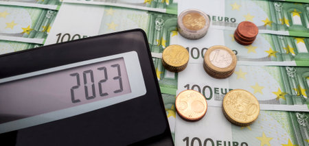 New financial year 2023. Calculator on the background of banknotes of 100 euros. The concept of...