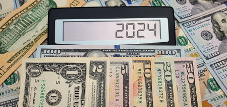 Military spending and the new year 2024. Calculator on the background of US dollar banknotes. USA,...