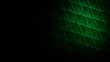 Dark geometric grid texture with striking green tones and subtle shadows, offering a grainy industrial design perfect for modern digital backgroundsの写真素材