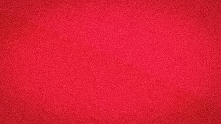 A vibrant and rich abstract background with a subtle gradient in bright scarlet and deep crimson tones, featuring a lovely, grainy textureの写真素材