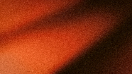 A warm and dramatic 4K abstract background with a smooth grainy gradient of fiery orange, deep red, and rich black tonesの写真素材