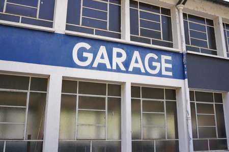 Garage sign on building facade with windows, industrial urban architecture detail