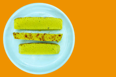 Gujarati famous dhokla Isolated with Saffron Color Background