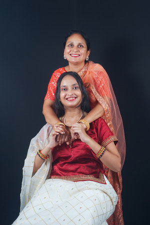 This vibrant stock image captures the joyous essence of Navratri, showcasing a mother and daughter...