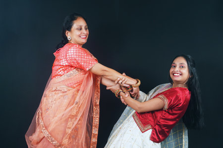 A stunning Indian mother and her daughter are engaging in the traditional folk dance of Gujarat....