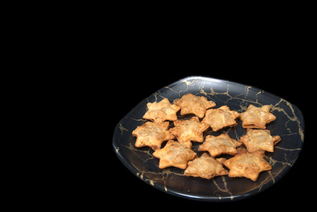 Dazzling Starry Aloo Puff Pastries on Glossy Black Marble - The Ultimate Party Treat!の写真素材