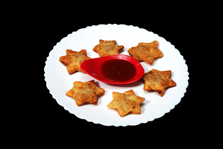 Golden-Brown Star Aloo Puff Pastries with a Tangy Tomato Kick - A Delightful Addition to Any Festive Table!の写真素材