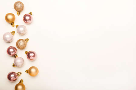 Christmas composition. Christmas pink and gold decorations on white background. Flat lay, top view, copy spaceの写真素材