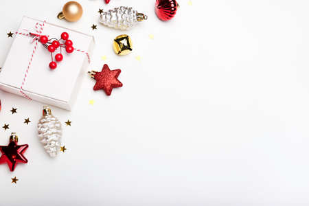 Christmas composition. Christmas toys, gift and sparkles on a white background. Flat lay, top view, copy spaceの写真素材