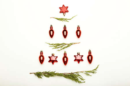 Christmas composition. Fir tree branches, red decorations on white background.Flat lay, top view, copy spaceの写真素材