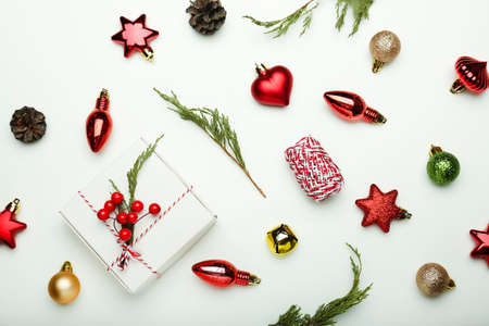 Christmas composition. Gifts, fir tree branches, red decorations on white background.Flat lay, top view, copy spaceの写真素材