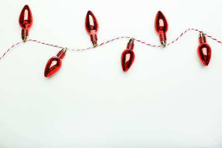 Christmas composition. Red toys and fir branches on a red background. Flat lay, top view, copy spacの写真素材